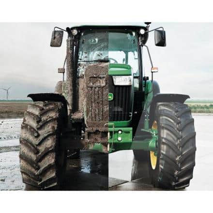 A green tractor shown split down the middle; the left side is covered in mud, while the right side is clean, on a farm background.